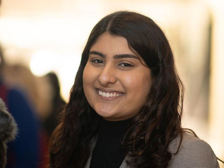 Student smiling and looking at the cameera.